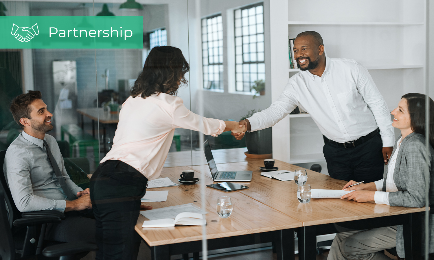 Man and woman in office having a handshake